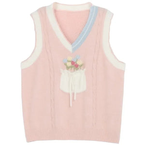 kawaii pink knit sweater vest floral bouquet bow pocket pastel blue cream trim product flat lay
