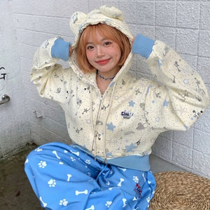 kawaii star print zip-up hoodie light yellow blue cuffs seated model cutecore harajuku